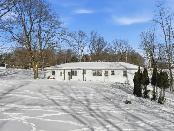 a view of a house with snow on the road