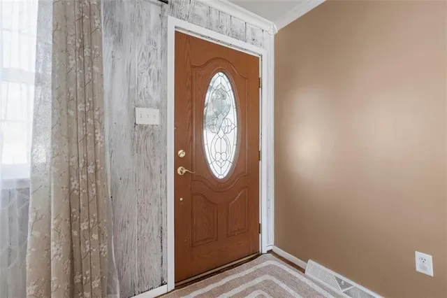 a view of front door with wooden door