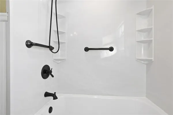 a view of a room with wooden floor and white walls