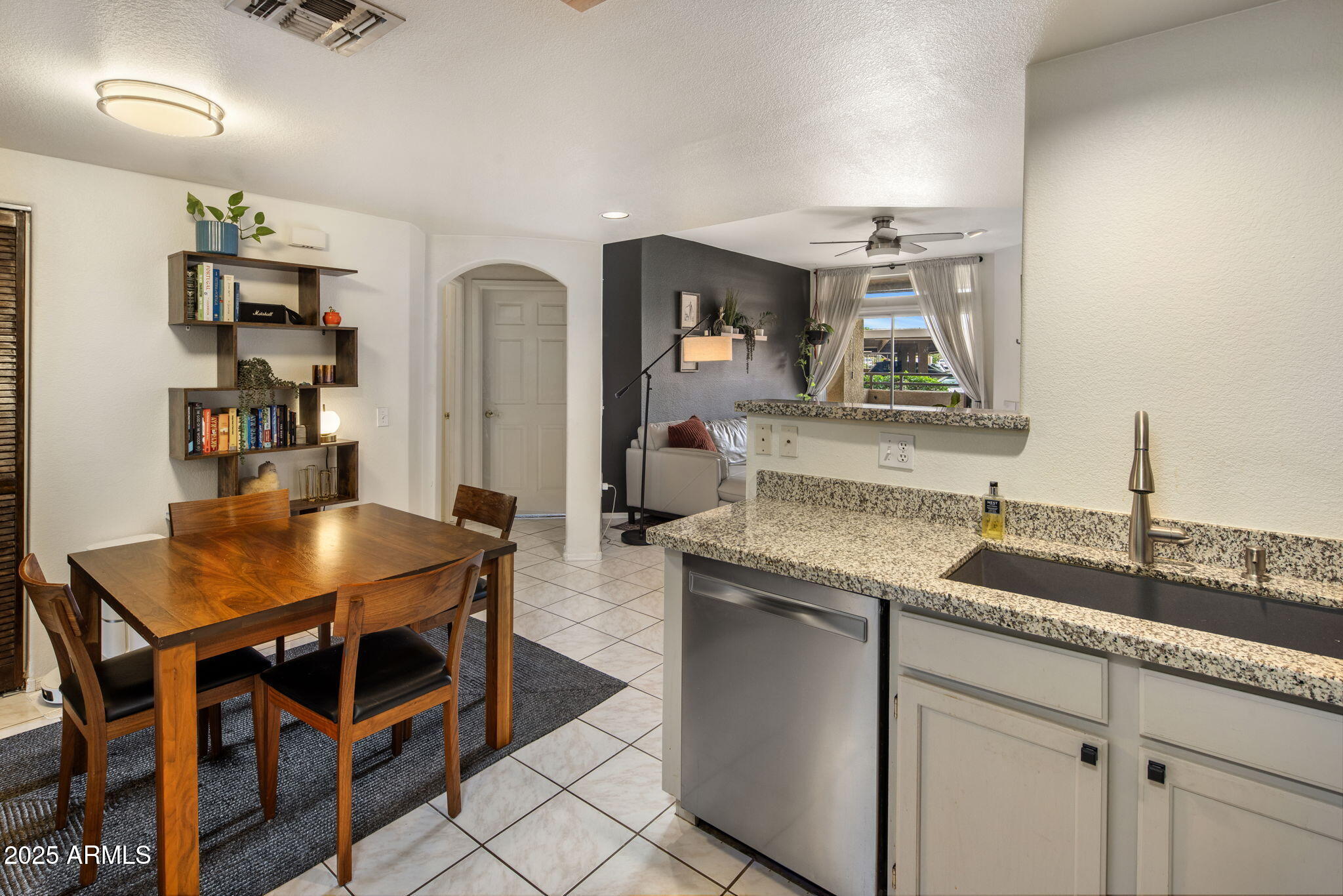 10410 North Cave Creek Road, Unit 1115 Phoenix, AZ 85020 - Photo 7 of 19 a kitchen with granite countertop a sink and cabinets