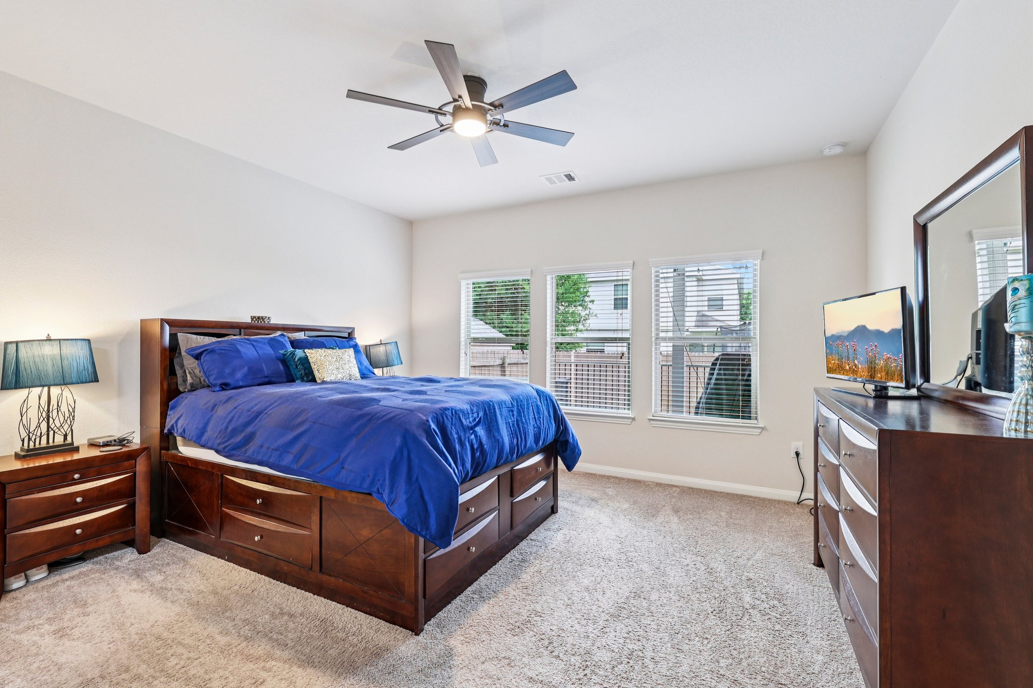 10033 Gertrudis Loop Austin, TX 78747 - Photo 19 of 39 This room features light-colored walls, carpeted flooring, and a ceiling fan with integrated lighting