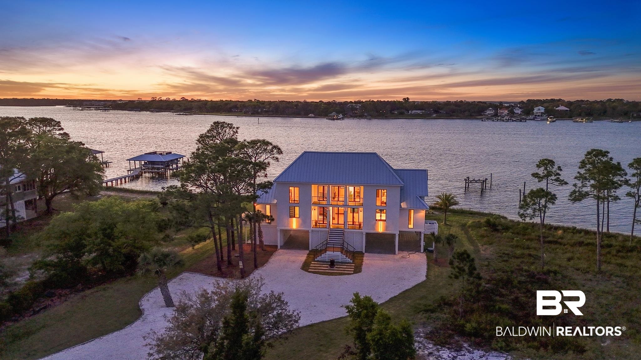 33349 River Road Orange Beach, AL 36561 - Photo 45 of 61 Waterfront residence featuring a metal roof, elevated foundation, multiple windows, and a private boat dock