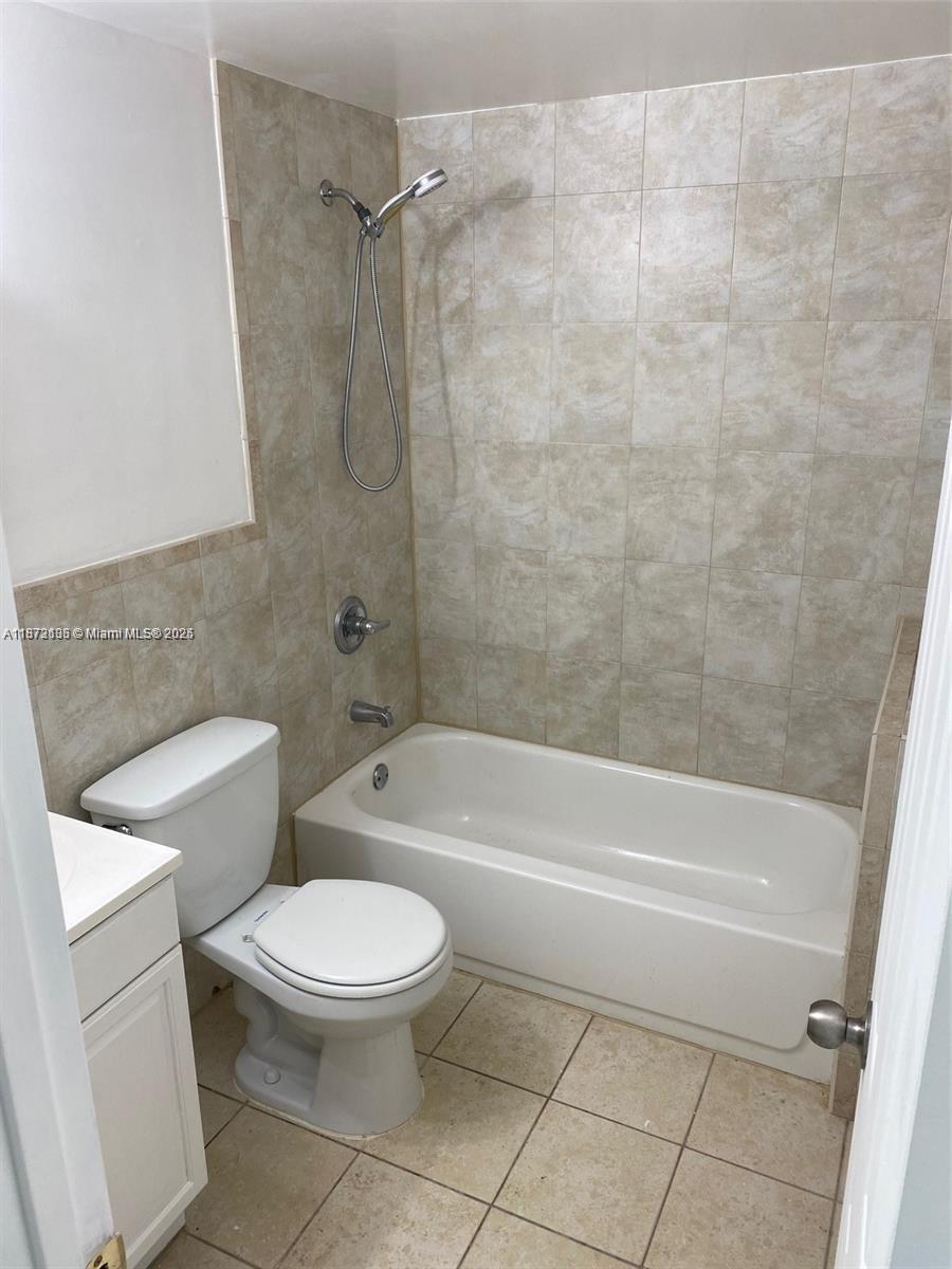 7390 Southwest 30th Terrace, Unit 2 Miami, FL 33155 - Photo 3 of 9 a bathroom with a toilet and a bath tub