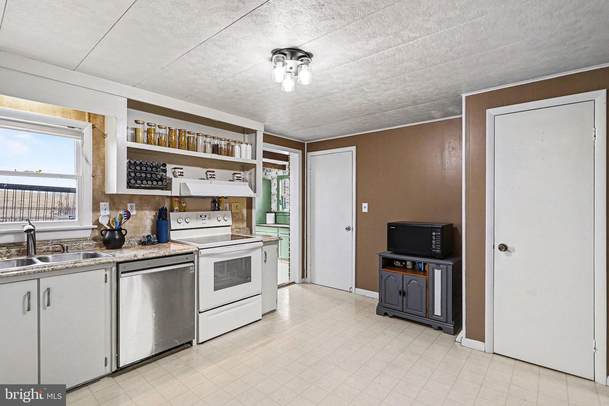 5405 West Canal Road East Berlin, PA 17316 - Photo 12 of 45 a kitchen with stainless steel appliances a stove a sink and a refrigerator