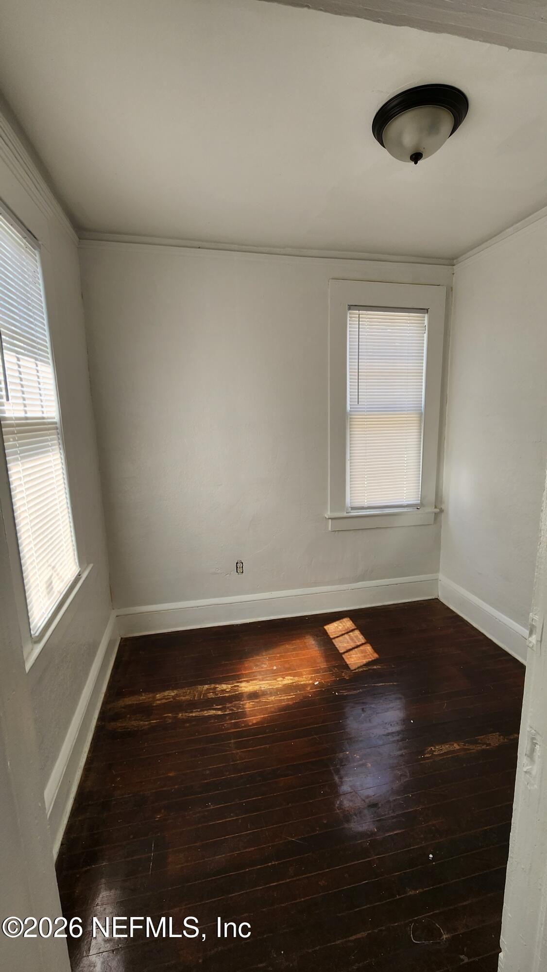 2036 Moncrief Road Jacksonville, FL 32209 - Photo 19 of 32 an empty room with wooden floor and windows