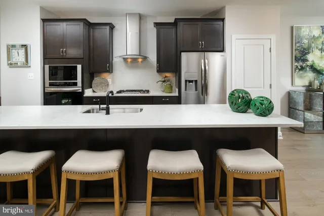 a kitchen with a table chairs refrigerator and cabinets