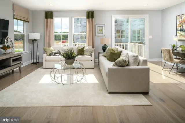 a living room with furniture and large windows