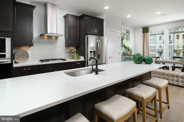 a kitchen with stainless steel appliances a sink and a refrigerator