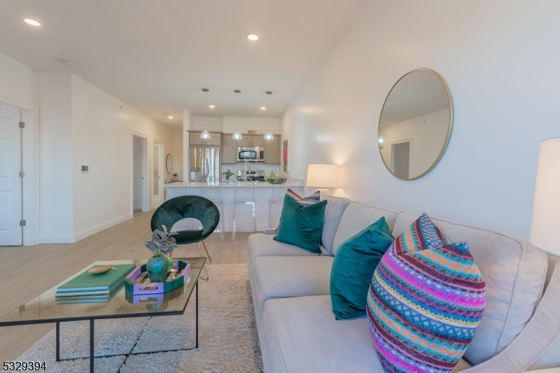 1026 Stuyvesant Avenue, Unit 305 Union, NJ 07083 - Photo 2 of 7 a living room with furniture and a chandelier