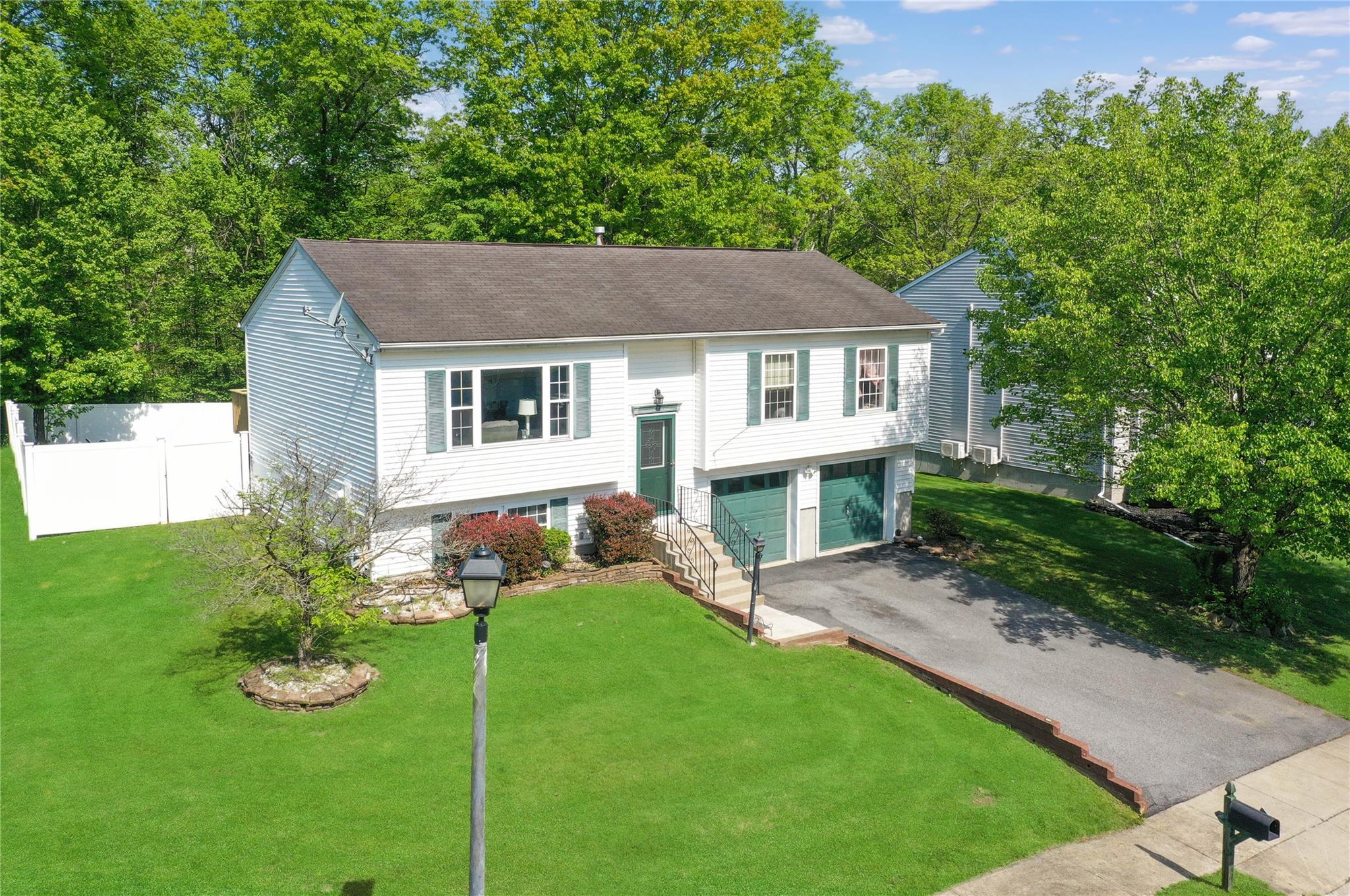 15 Brook Road Walden, NY 12586 - Photo 1 of 1 Split foyer home with asphalt driveway, a shingled roof, and a garage