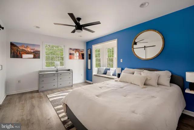 a bedroom with a large bed and a chandelier