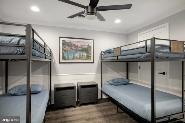 a bedroom with a bed and a ceiling fan