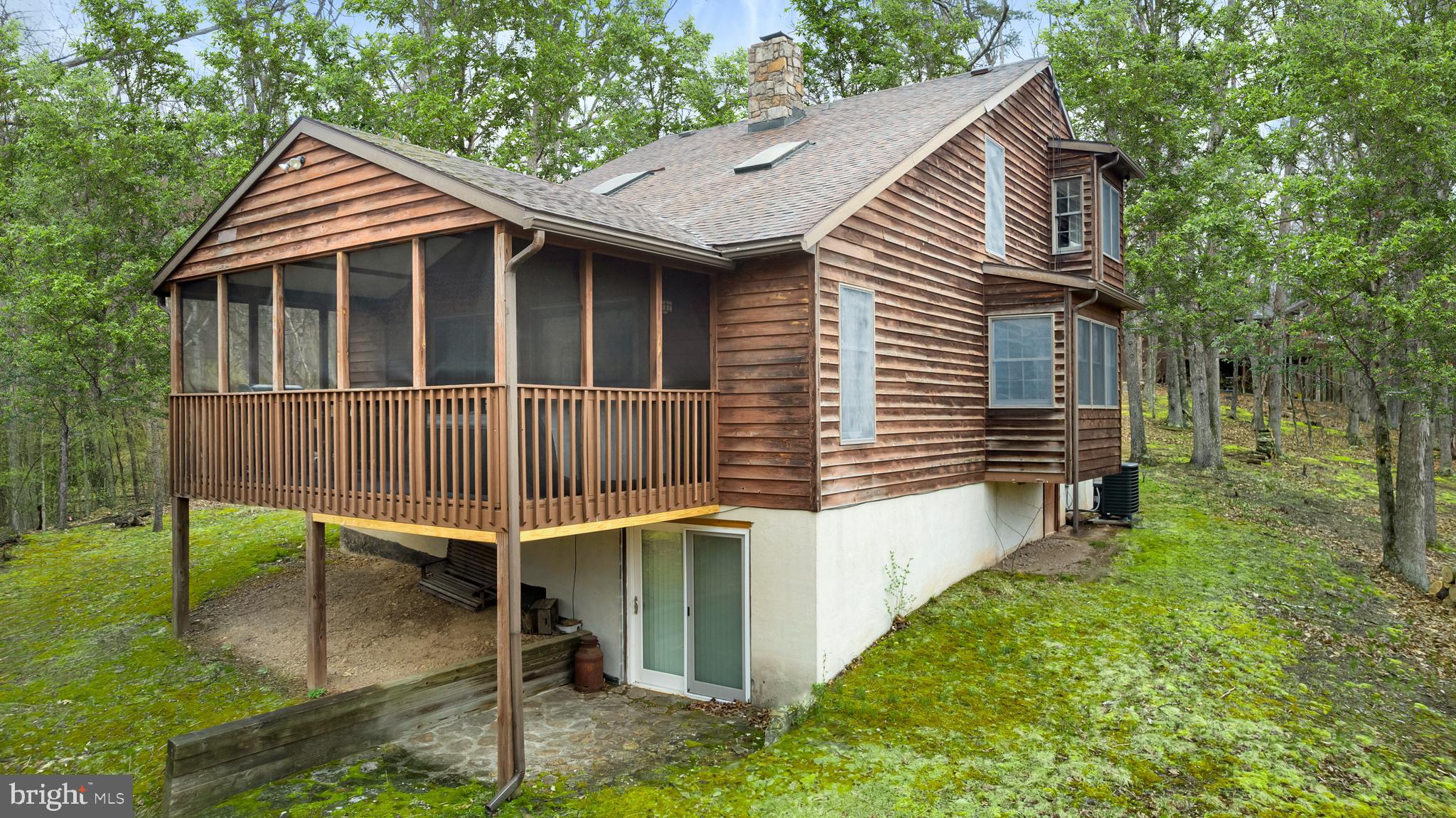 170 Cardinal Lane Berkeley Springs, WV 25411 - Photo 2 of 26 a backyard of a house with table and chairs