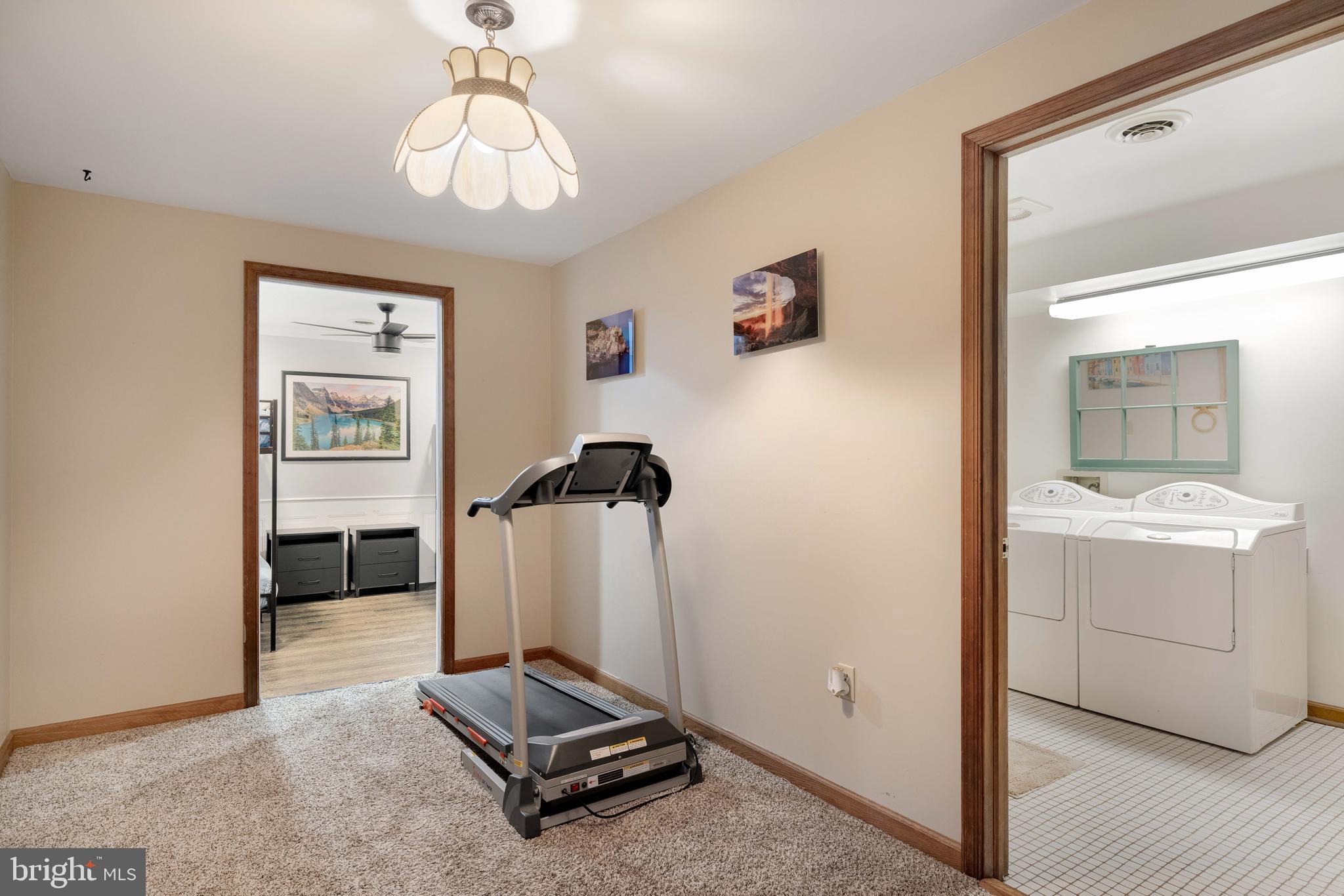 170 Cardinal Lane Berkeley Springs, WV 25411 - Photo 21 of 26 a room with gym equipment and a mirror