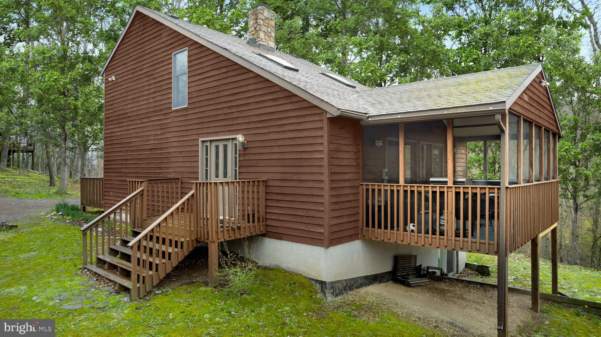 170 Cardinal Lane Berkeley Springs, WV 25411 - Photo 23 of 26 a view of a house with a yard and wooden deck