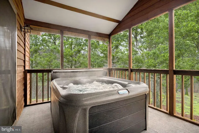 a bed sitting in a balcony next to a yard