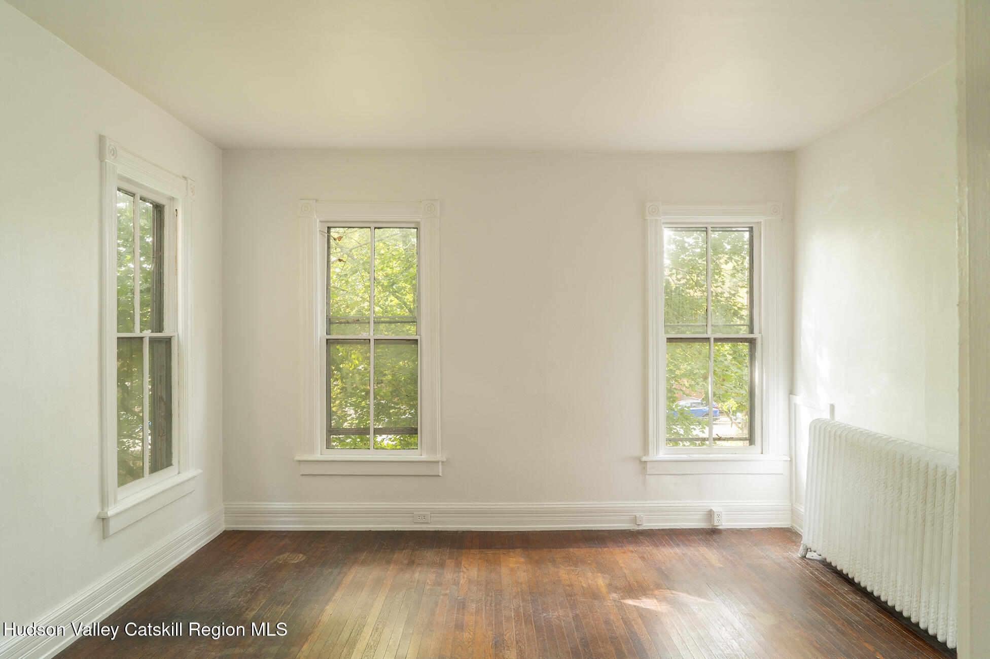 267 Main Street Catskill, NY 12414 - Photo 12 of 29 an empty room with wooden floor and windows
