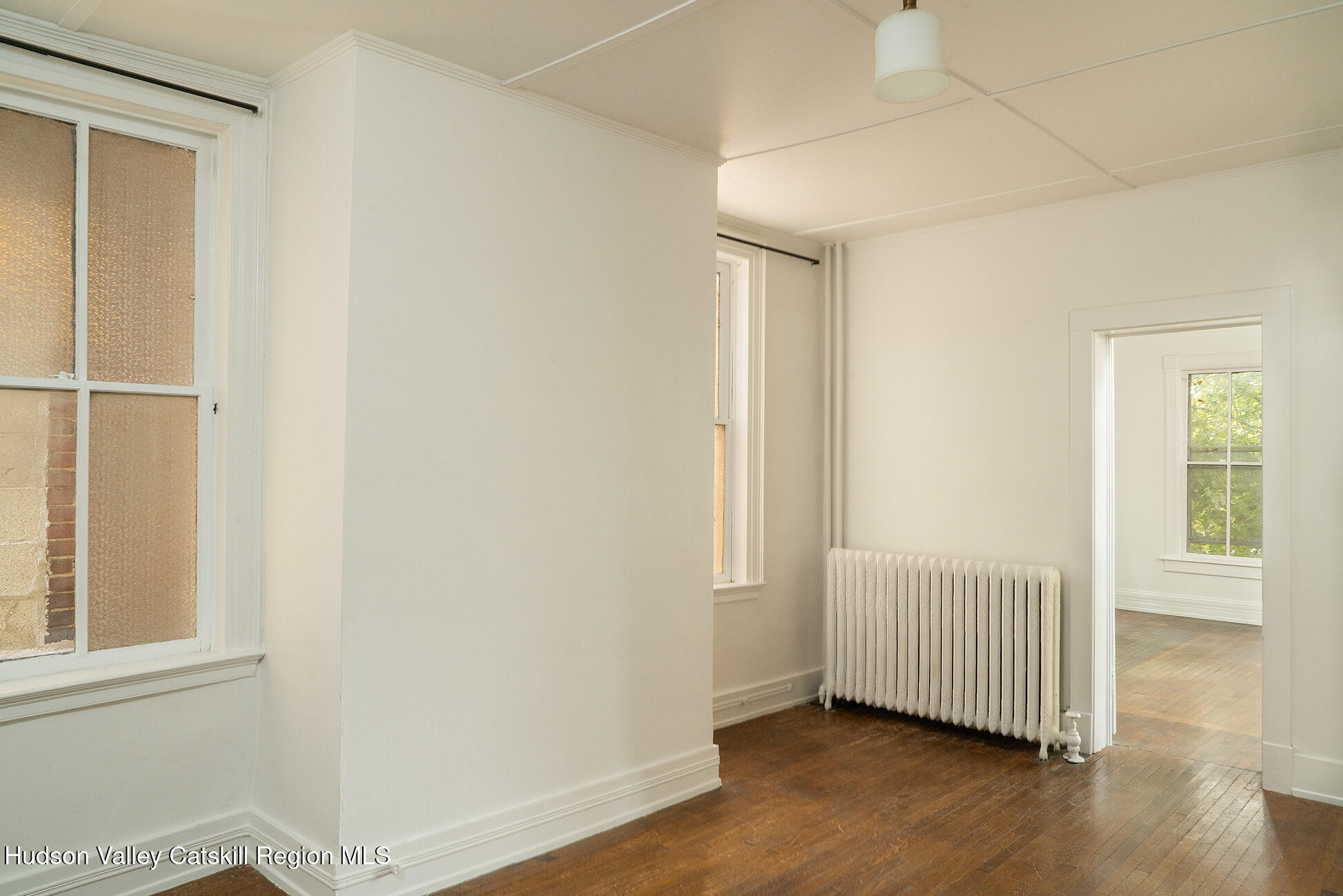 267 Main Street Catskill, NY 12414 - Photo 13 of 29 an empty room with wooden floor and windows