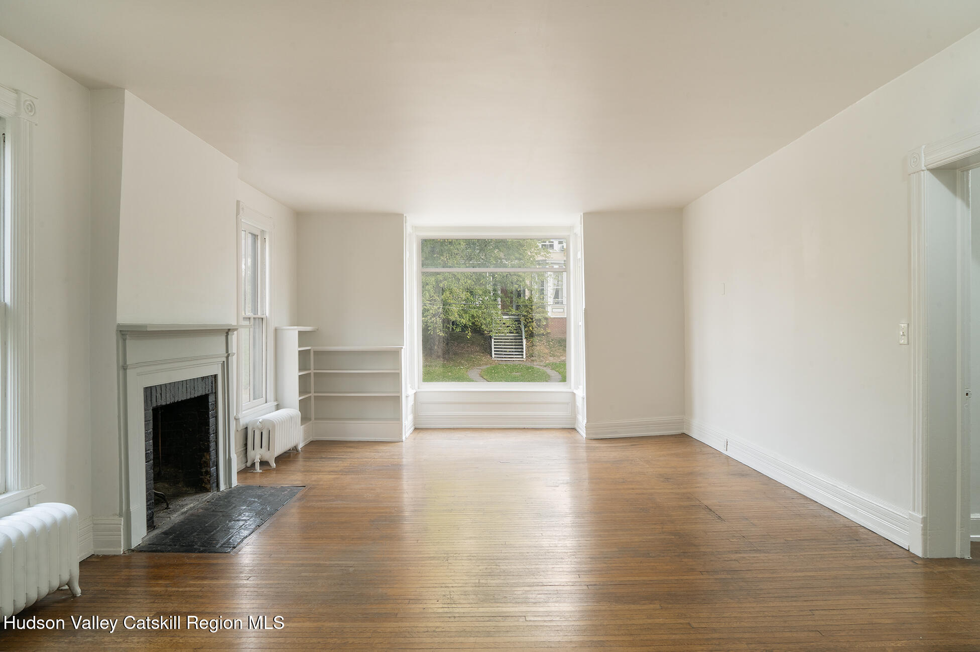 267 Main Street Catskill, NY 12414 - Photo 15 of 29 a view of empty room with wooden floor and fireplace