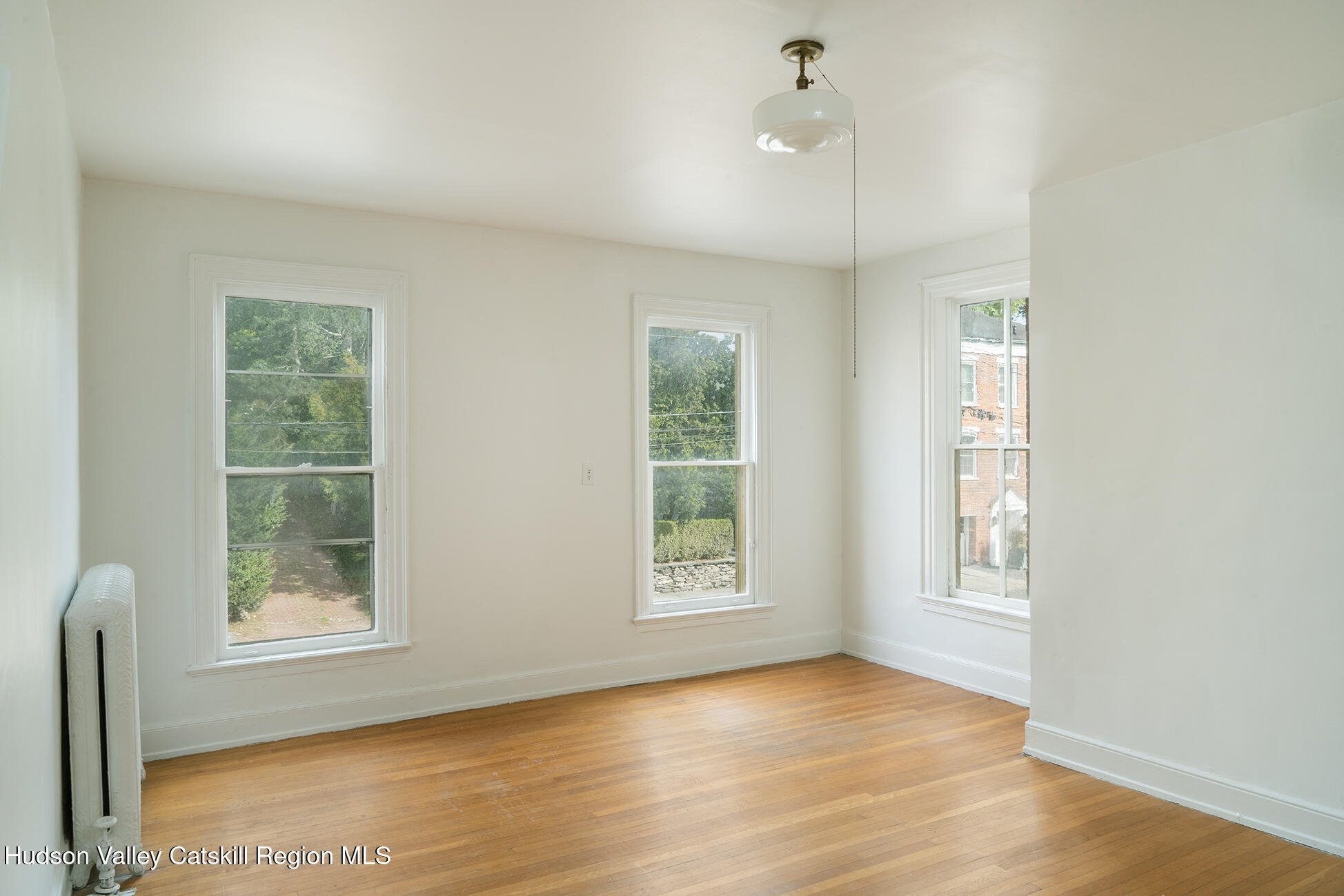 267 Main Street Catskill, NY 12414 - Photo 22 of 29 a view of an empty room with a window and wooden floor