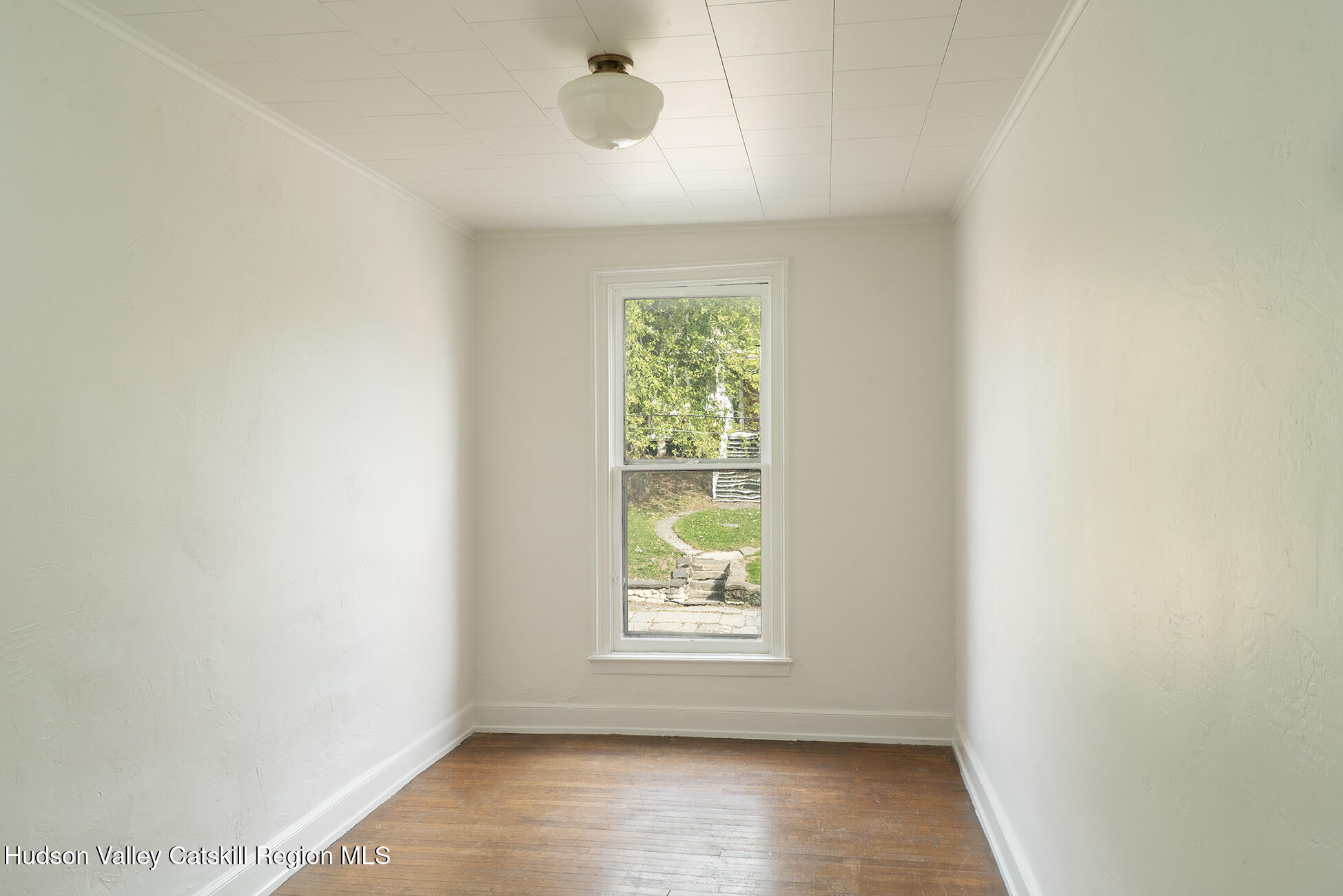 267 Main Street Catskill, NY 12414 - Photo 23 of 29 an empty room with wooden floor and windows