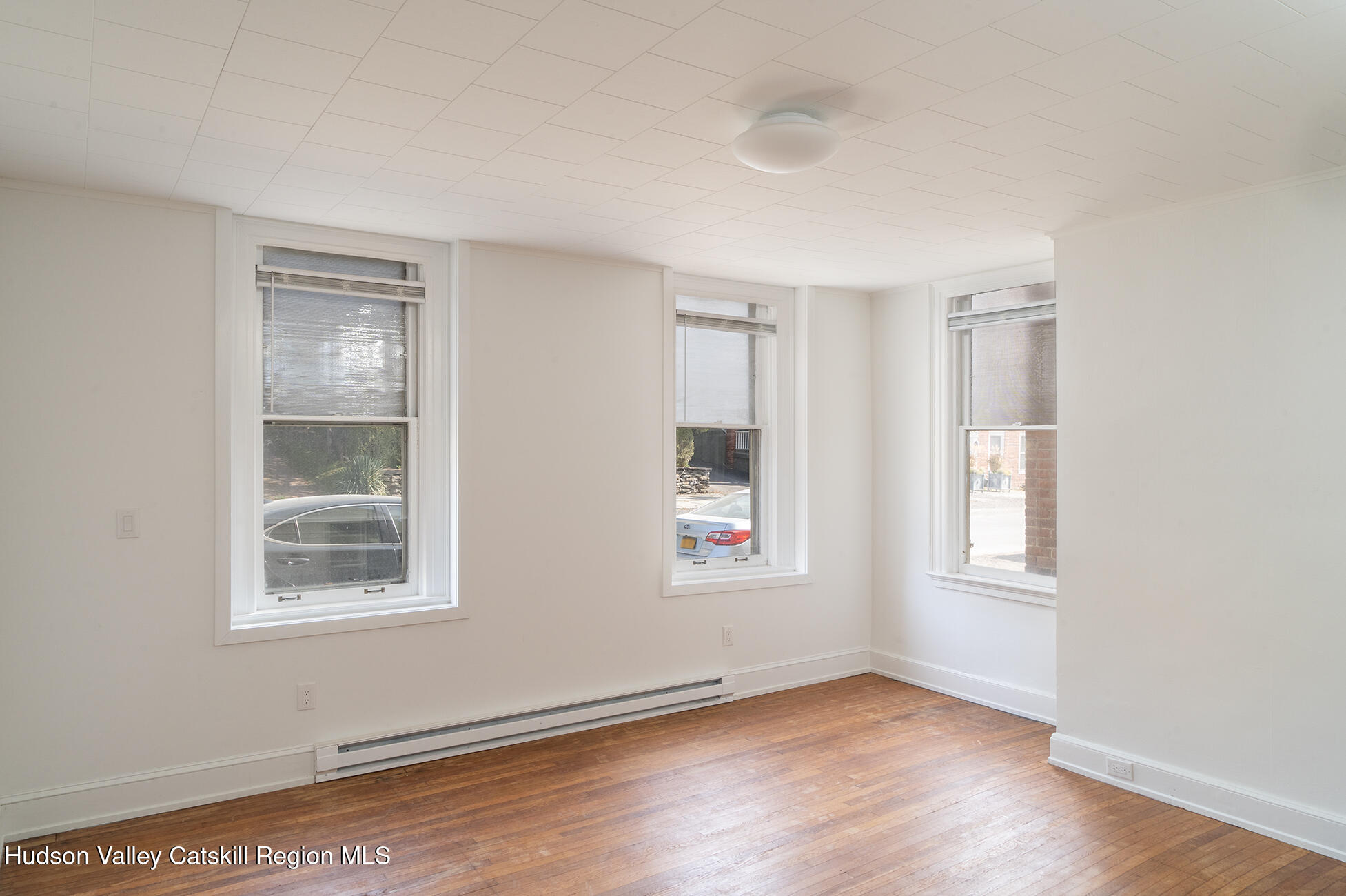 267 Main Street Catskill, NY 12414 - Photo 4 of 29 a view of an empty room with wooden floor and a window