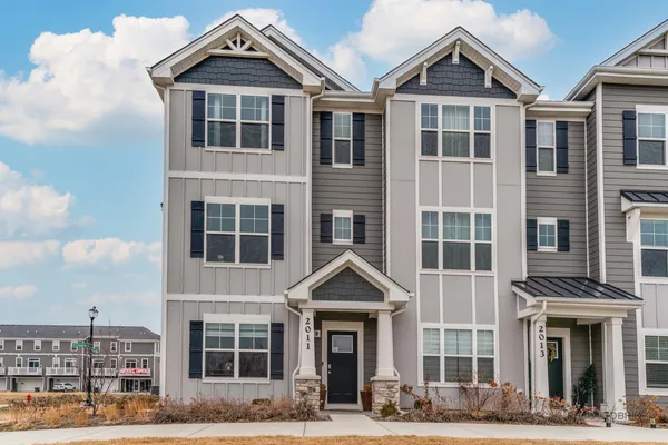 a front view of a residential apartment building with a yard