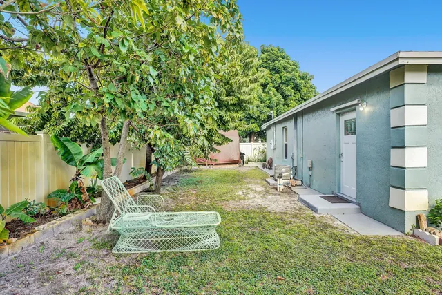 a view of a backyard with plants and a garden