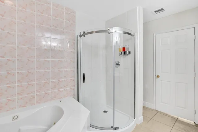 a bathroom with a shower and a tub