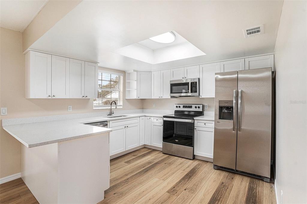 2527 Ridge Top Way Valrico, FL 33594 - Photo 7 of 29 a kitchen with a refrigerator stove and sink