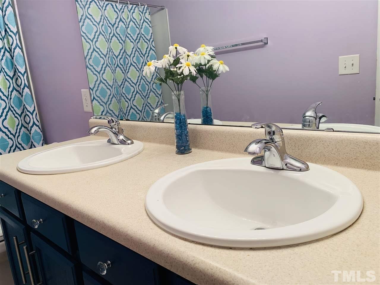 2529 Quarry Ridge Lane Raleigh, NC 27610 - Photo 22 of 26 a bathroom with a sink a toilet and a mirror