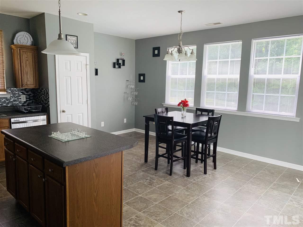 2529 Quarry Ridge Lane Raleigh, NC 27610 - Photo 8 of 26 a view of a dining room with furniture and window