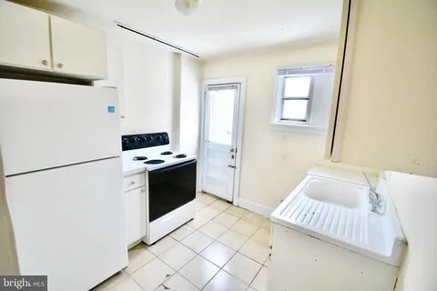 a kitchen with a refrigerator sink and stove
