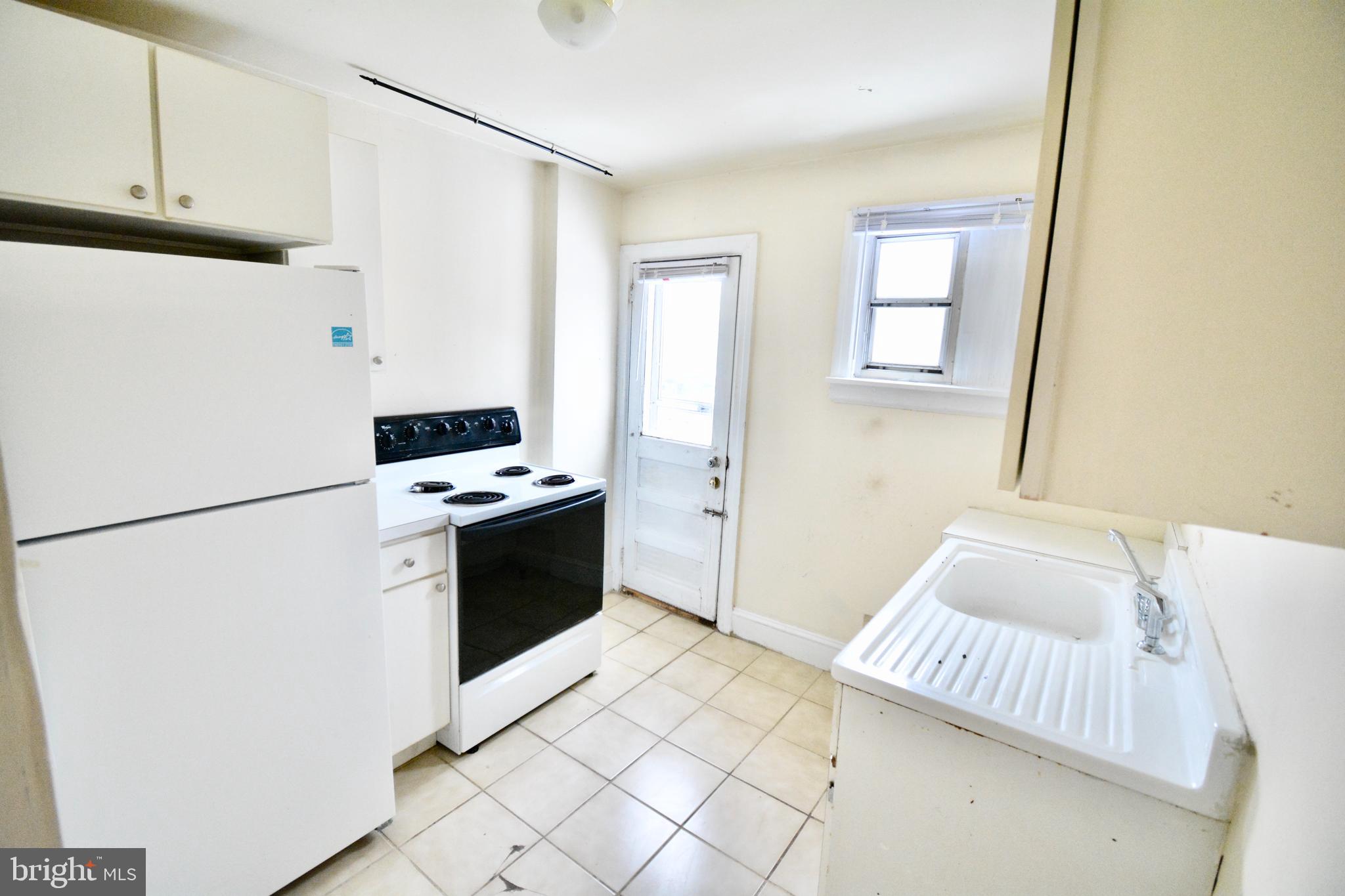 38 West Seymour Street, Unit 3 Philadelphia, PA 19144 - Photo 5 of 11 a kitchen with a refrigerator sink and stove