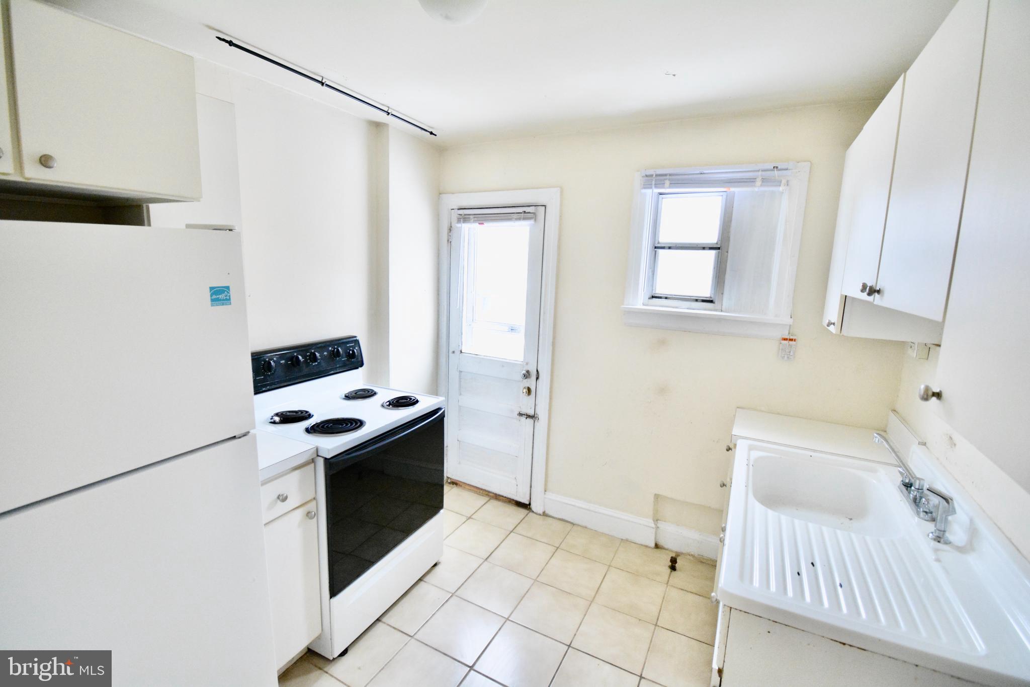 38 West Seymour Street, Unit 3 Philadelphia, PA 19144 - Photo 6 of 11 a kitchen with a stove and a refrigerator