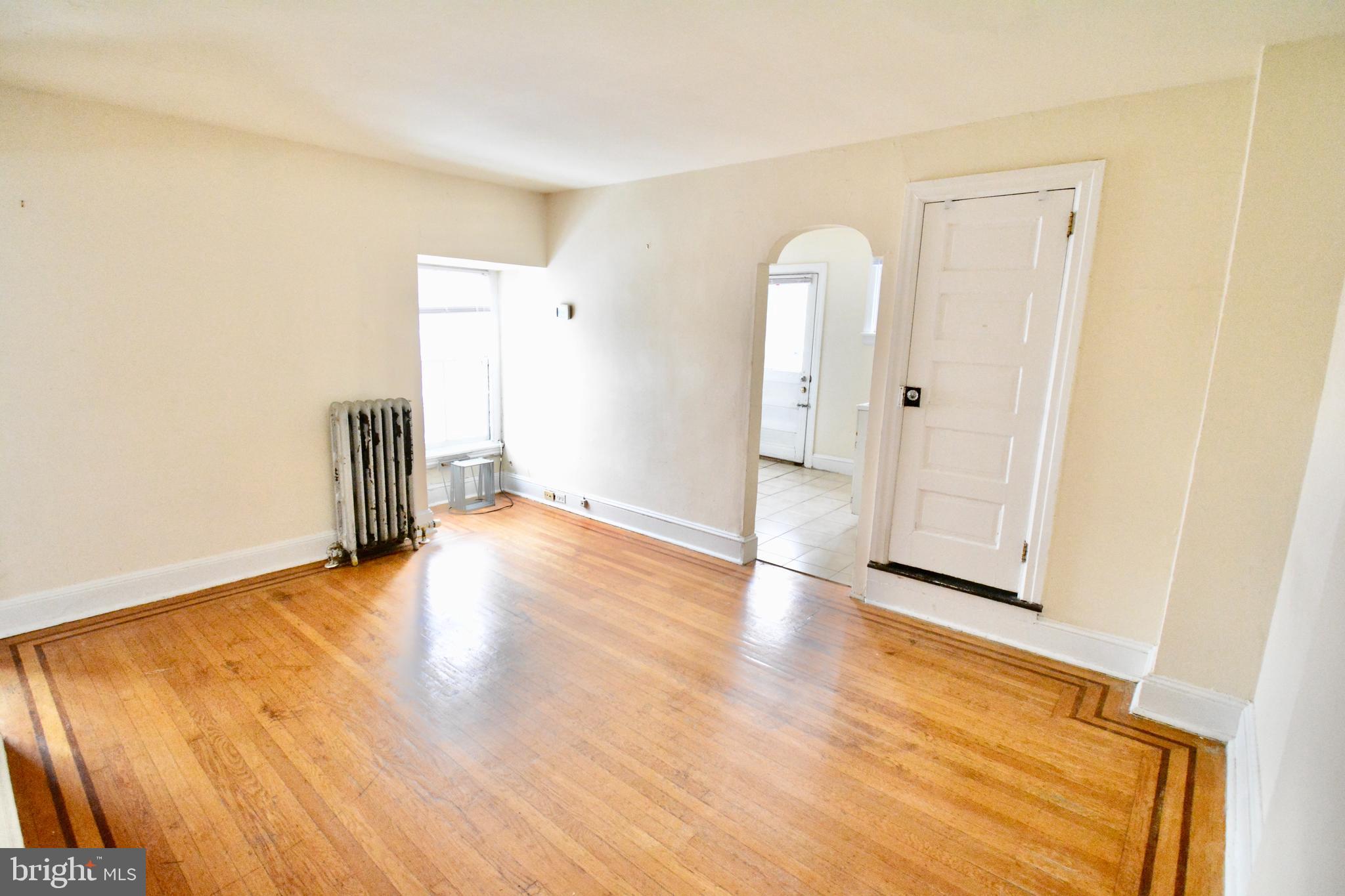 38 West Seymour Street, Unit 3 Philadelphia, PA 19144 - Photo 8 of 11 an empty room with wooden floor and window