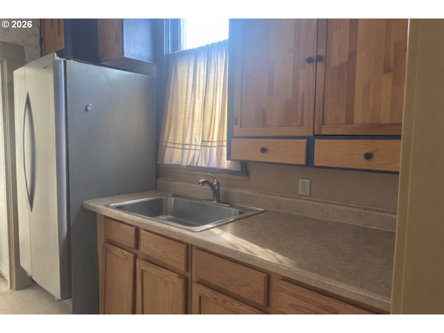 1787 Valley Avenue Baker City, OR 97814 - Photo 11 of 13 a kitchen with a sink and a refrigerator