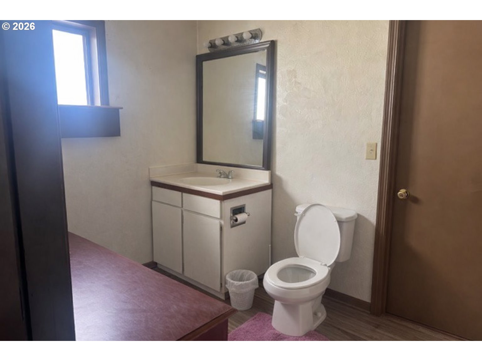 1787 Valley Avenue Baker City, OR 97814 - Photo 12 of 13 a bathroom with a toilet a sink and a mirror