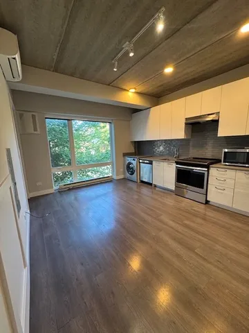 a view of a kitchen with a sink and a window