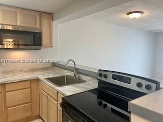 345 Ocean Drive, Unit 904 Miami Beach, FL 33139 - Photo 5 of 36 a view of a kitchen with a sink and cabinets