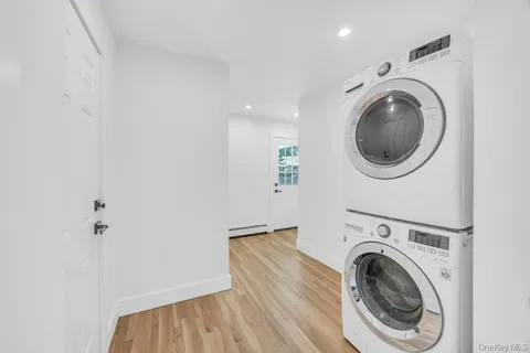 a kitchen with stainless steel appliances granite countertop a stove a sink dishwasher and a refrigerator with wooden floor