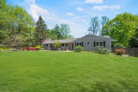 a front view of house with yard and green space