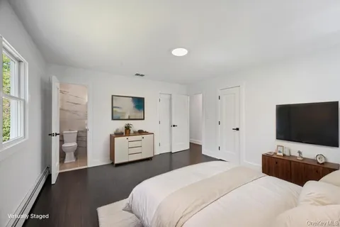 a bathroom with a granite countertop sink a toilet a mirror and shower