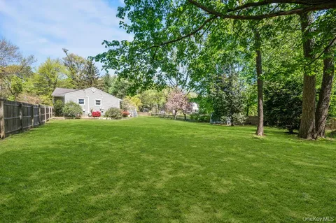 a view of a deck with couches wooden floor and fence