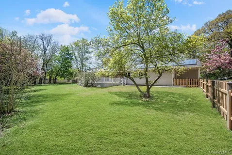a view of a field of grass and trees