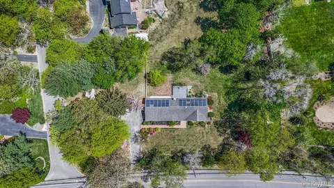 an aerial view of a house with a yard