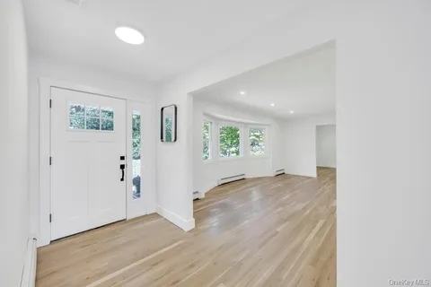 an empty room with windows and closet