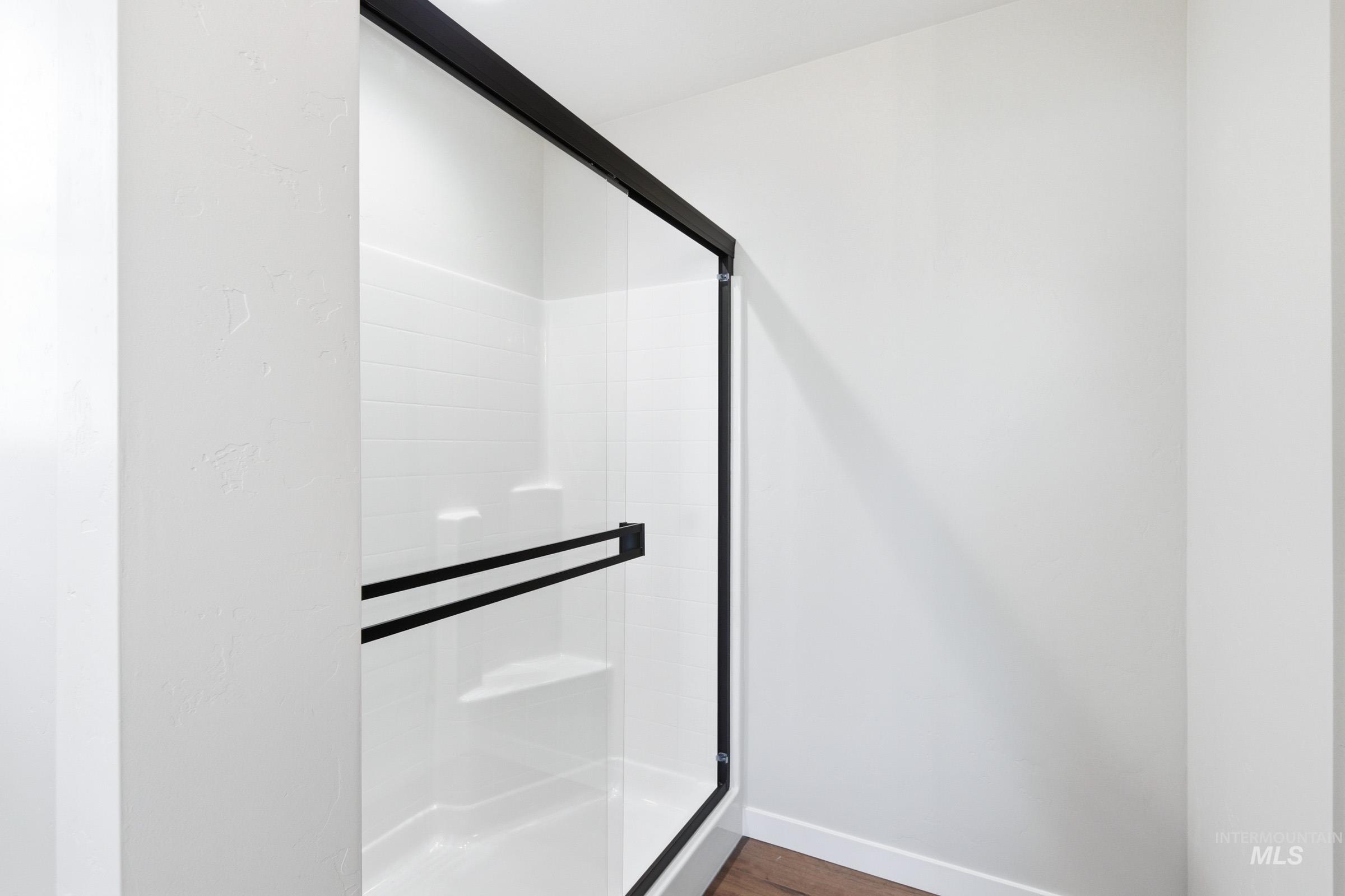 12805 Decatur Street Nampa, ID 83651 - Photo 20 of 20 Enclosed shower featuring a clear glass door with matte black framing and hardware