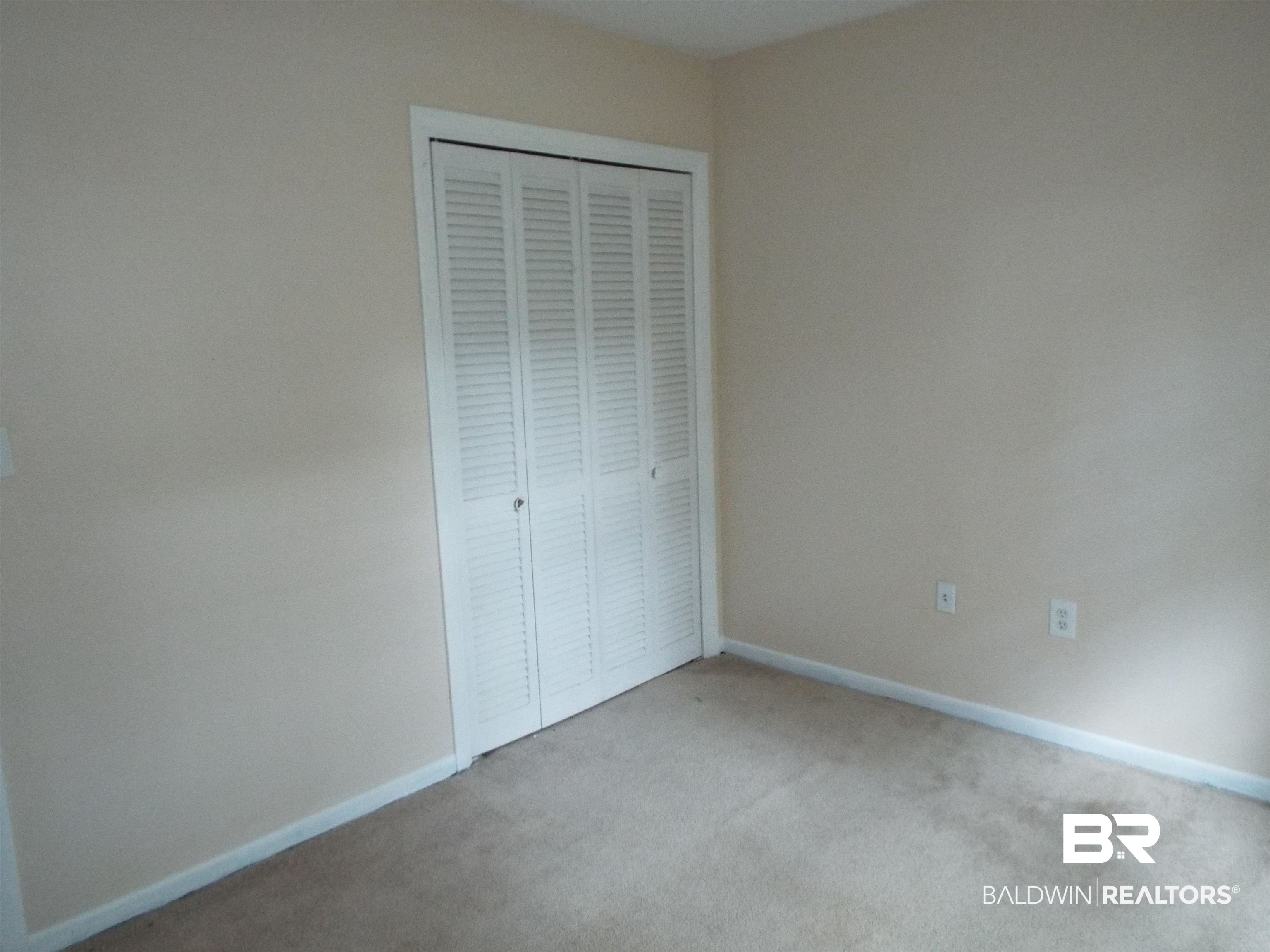 604 Southern Way Spanish Fort, AL 36527 - Photo 6 of 13 Unfurnished bedroom with light colored carpet and a closet