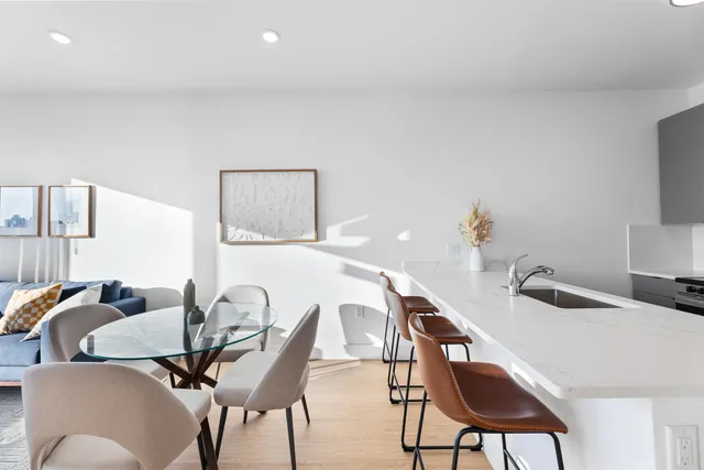 a dining room with furniture and wooden floor